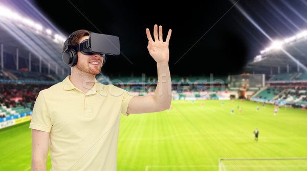 man in virtual reality headset over football field Stock photo © dolgachov