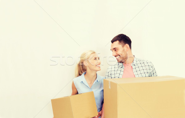 couple with delivery boxes moving to new home Stock photo © dolgachov