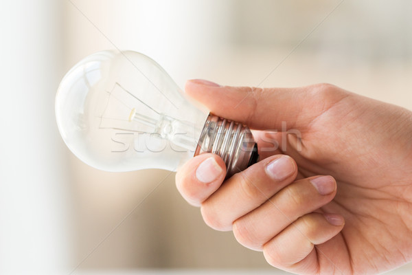 close up of hand holding edison lamp or lightbulb Stock photo © dolgachov
