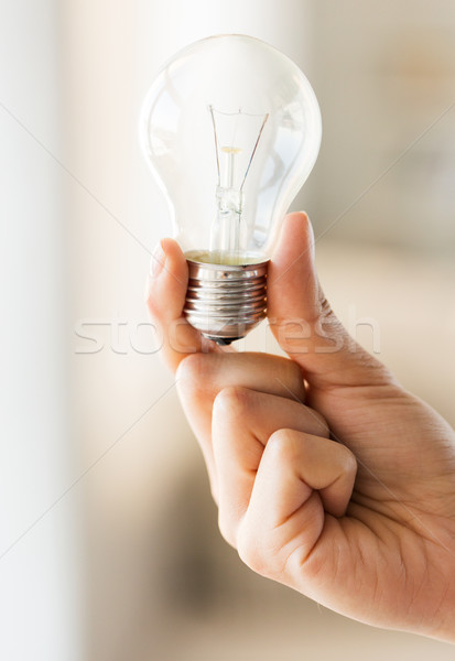 close up of hand holding edison lamp or lightbulb Stock photo © dolgachov