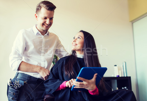 happy woman and stylist with tablet pc at salon Stock photo © dolgachov
