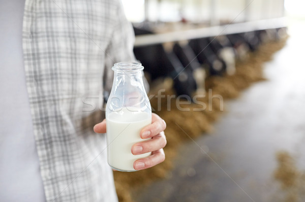 close up of man or farmer with milk on dairy farm Stock photo © dolgachov