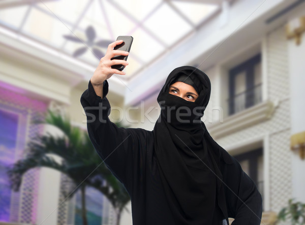 muslim woman in hijab taking selfie by smartphone Stock photo © dolgachov