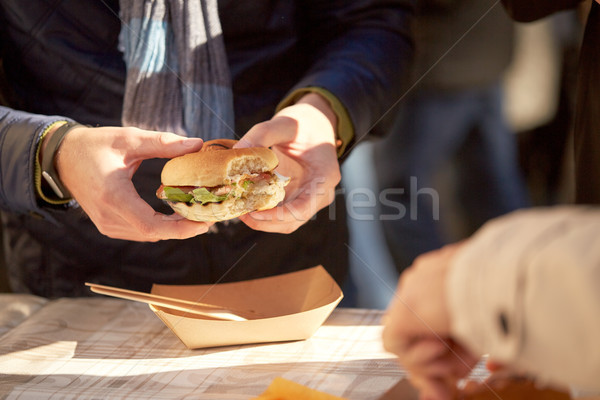 Foto stock: Mãos · homem · alimentação · hambúrguer · ao · ar · livre · fast-food