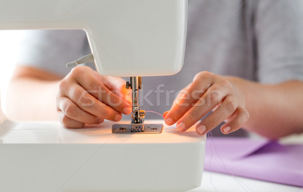 tailor woman threading needle of sewing machine Stock photo © dolgachov