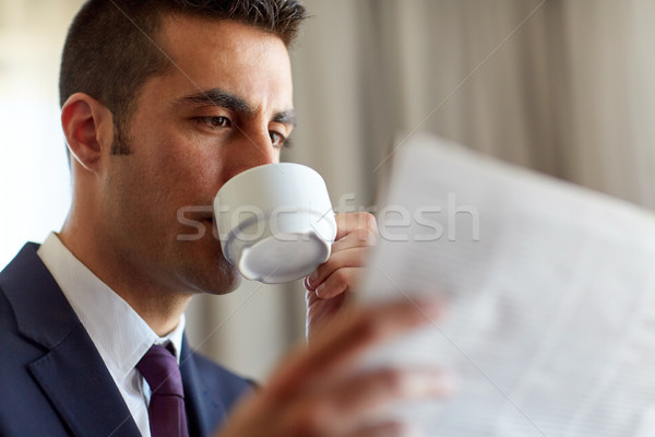 businessman reading newspaper and drinking coffee Stock photo © dolgachov
