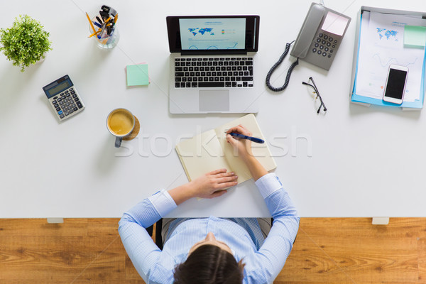 Stockfoto: Zakenvrouw · schrijven · notebook · kantoor · zakenlieden · werk