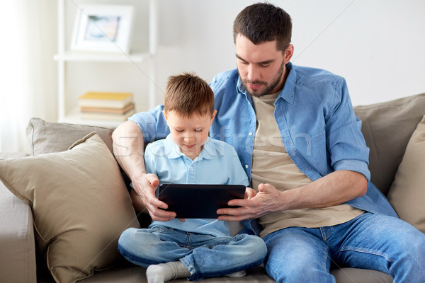 father and son with tablet pc playing at home Stock photo © dolgachov