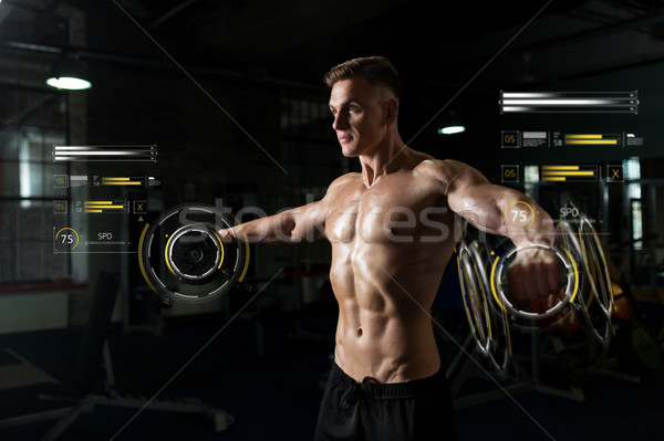 close up of man with dumbbells exercising in gym Stock photo © dolgachov