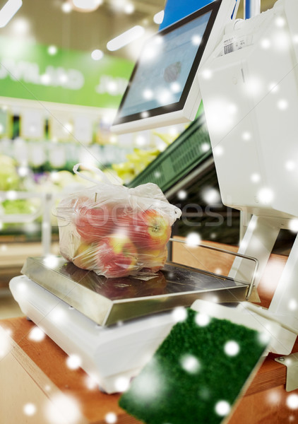 apples in plastic bag on scale at grocery store Stock photo © dolgachov