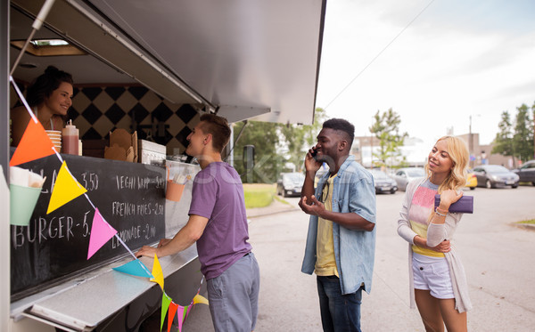 happy customers queue at food truck Stock photo © dolgachov
