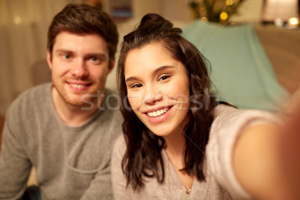 happy couple taking selfie at home Stock photo © dolgachov