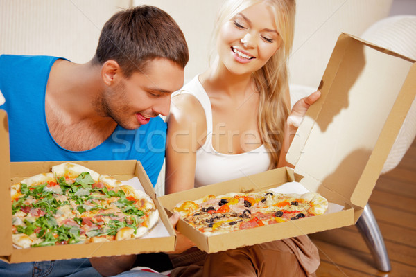 romantic couple eating pizza at home Stock photo © dolgachov