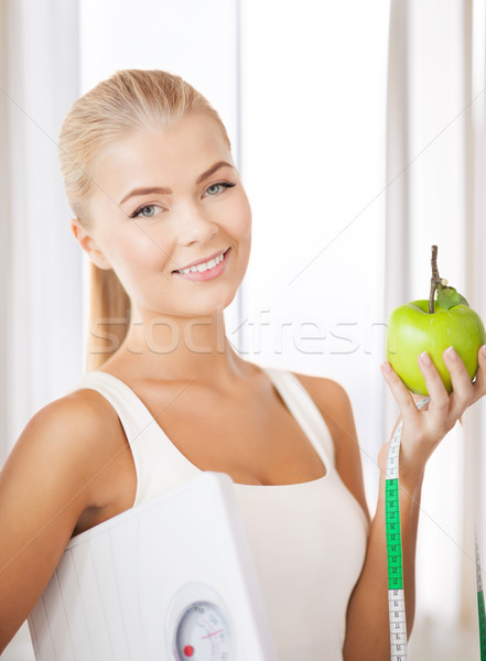 Stock photo: sporty woman with scale, apple and measuring tape