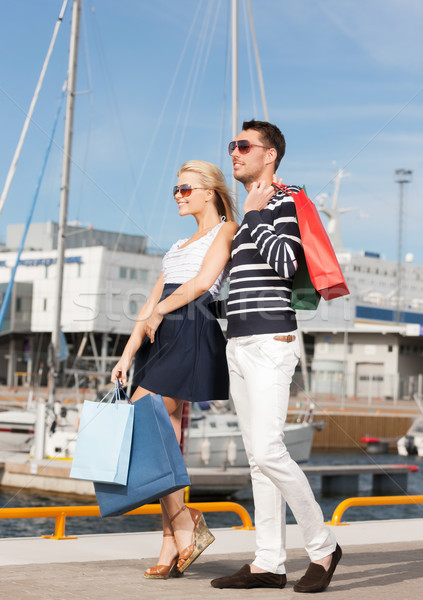 Stock photo: young couple in duty free shopping bags
