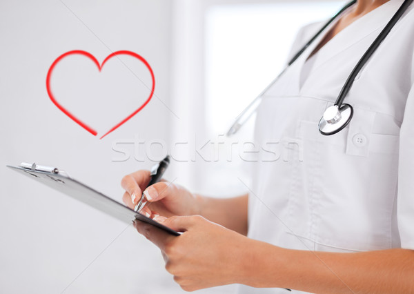 female doctor with stethoscope and prescription Stock photo © dolgachov