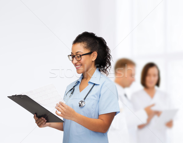 smiling female african american doctor or nurse Stock photo © dolgachov