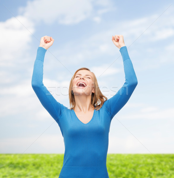 laughing young woman with hands up Stock photo © dolgachov