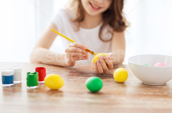 close up of girl coloring eggs for easter Stock photo © dolgachov