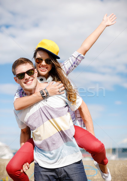 smiling teenagers in sunglasses having fun outside Stock photo © dolgachov