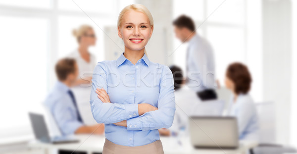 young smiling businesswoman with crossed arms Stock photo © dolgachov
