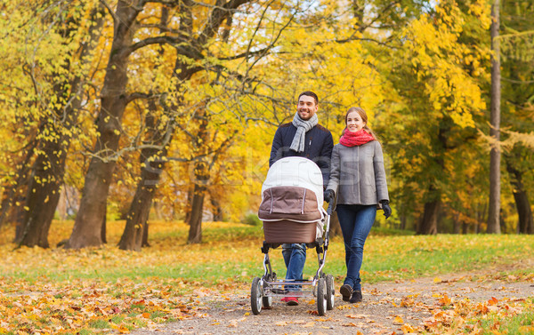 Uśmiechnięty para baby wózki dla dzieci jesienią parku Zdjęcia stock © dolgachov