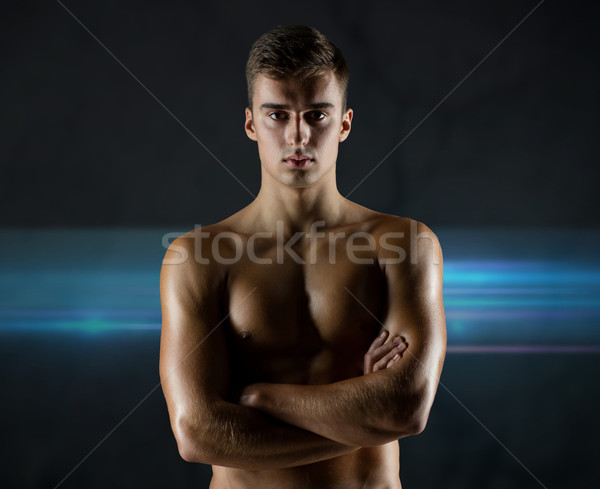 young male bodybuilder with bare muscular torso Stock photo © dolgachov