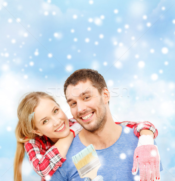 smiling couple with paintbrush Stock photo © dolgachov