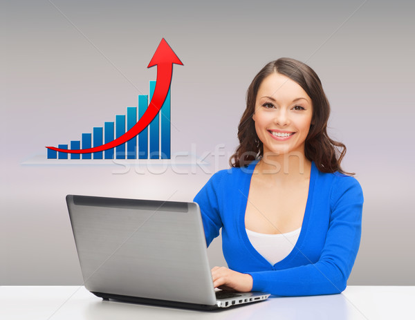 Stock photo: smiling woman with laptop and growth chart