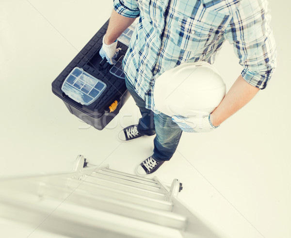 man with ladder, helmet and toolkit Stock photo © dolgachov