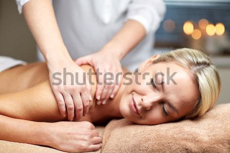 close up of woman having hot stone massage in spa Stock photo © dolgachov