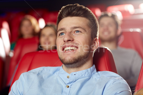 happy young man watching movie in theater Stock photo © dolgachov