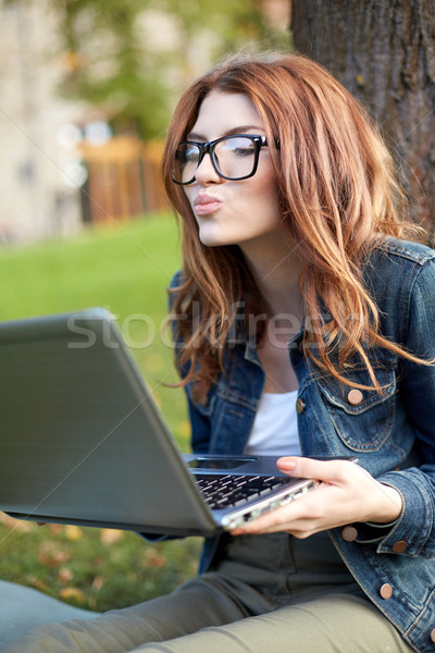 Heureux étudiant fille écrit portable campus [[stock_photo]] © dolgachov