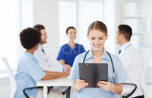 Stock photo: happy doctor over group of medics at hospital