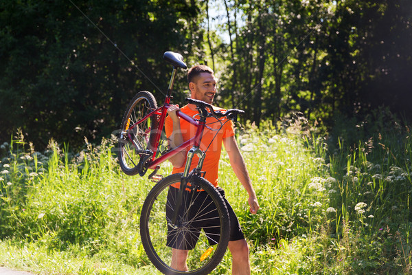 Heureux jeune homme équitation vélo extérieur fitness [[stock_photo]] © dolgachov