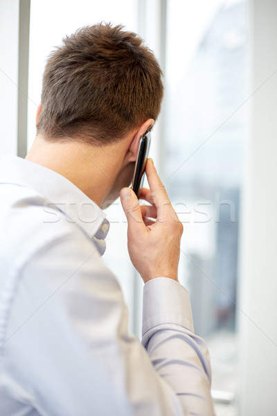 businessman calling on smartphone in office Stock photo © dolgachov
