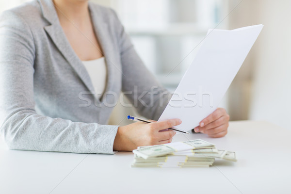 close up of female hands with money and tax report Stock photo © dolgachov