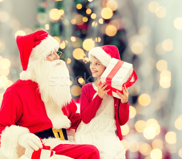 smiling little girl with santa claus and gifts Stock photo © dolgachov