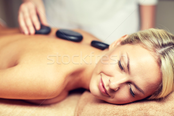 close up of woman having hot stone massage in spa Stock photo © dolgachov