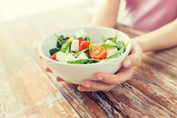close up of young woman hands showing salad bowl Stock photo © dolgachov