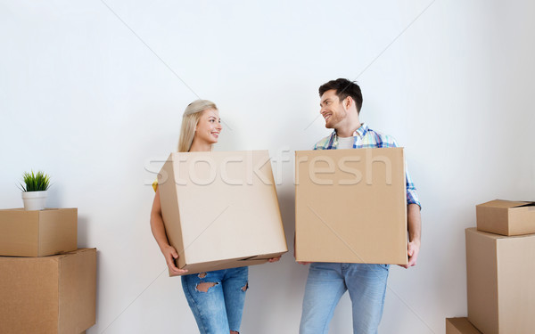 Sorridente casal grande caixas em movimento nova casa Foto stock © dolgachov