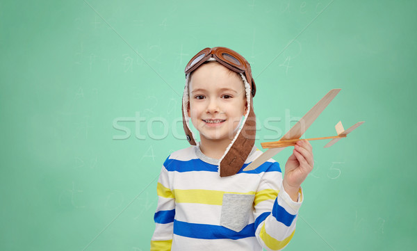 happy little boy in aviator hat with airplane Stock photo © dolgachov