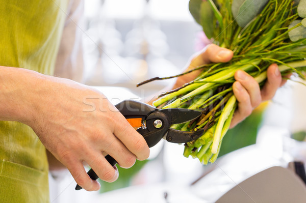 close up of florist man with flowers and pruner Stock photo © dolgachov