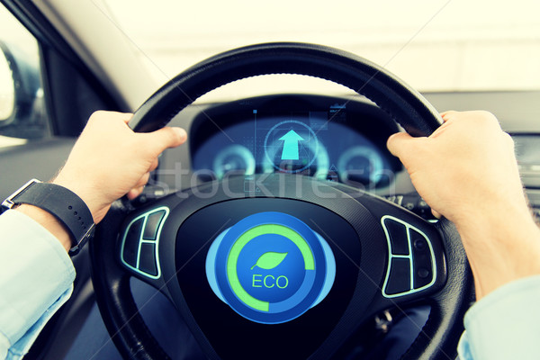 close up of young man driving car in eco mode Stock photo © dolgachov