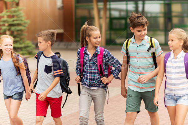 Groupe heureux école élémentaire élèves marche primaire [[stock_photo]] © dolgachov