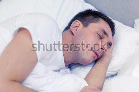 handsome man sleeping in bed Stock photo © dolgachov