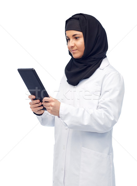 muslim female doctor in hijab with tablet pc Stock photo © dolgachov