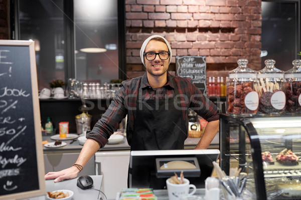 happy seller man or barman at cafe counter Stock photo © dolgachov