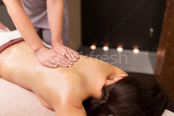 woman lying and having back massage at spa parlor Stock photo © dolgachov