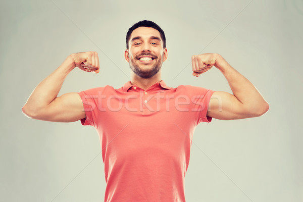 笑みを浮かべて 男 上腕二頭筋 グレー 電源 ストックフォト © dolgachov